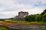 An ancient castle surrounded by lush green landscapes.