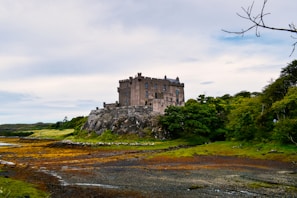 An ancient castle surrounded by lush green landscapes.