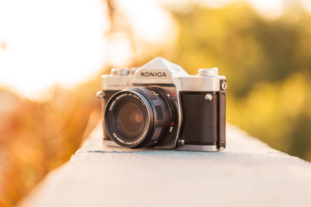 a camera sitting on top of a cement wall