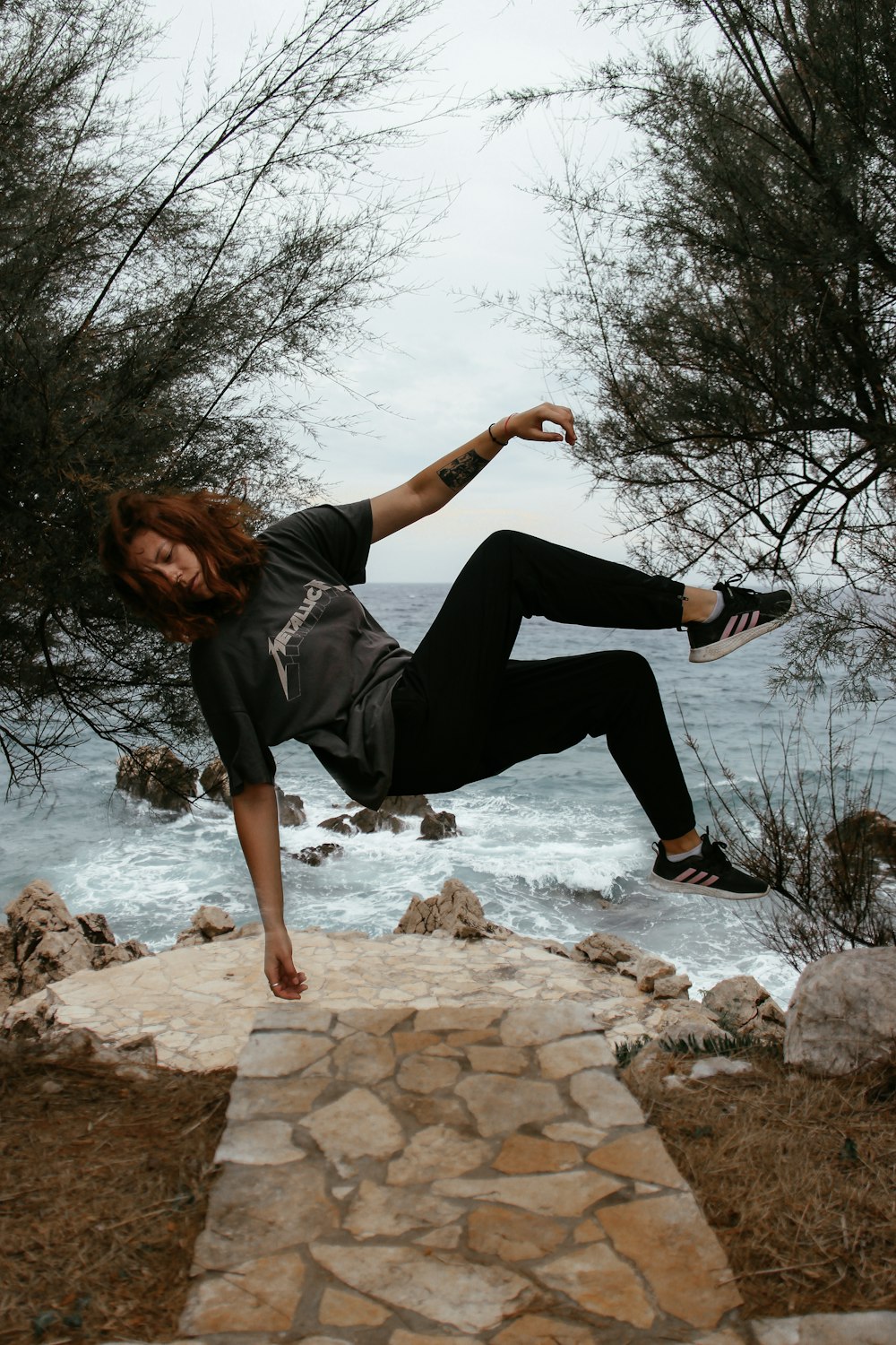 a woman is doing a trick on a skateboard