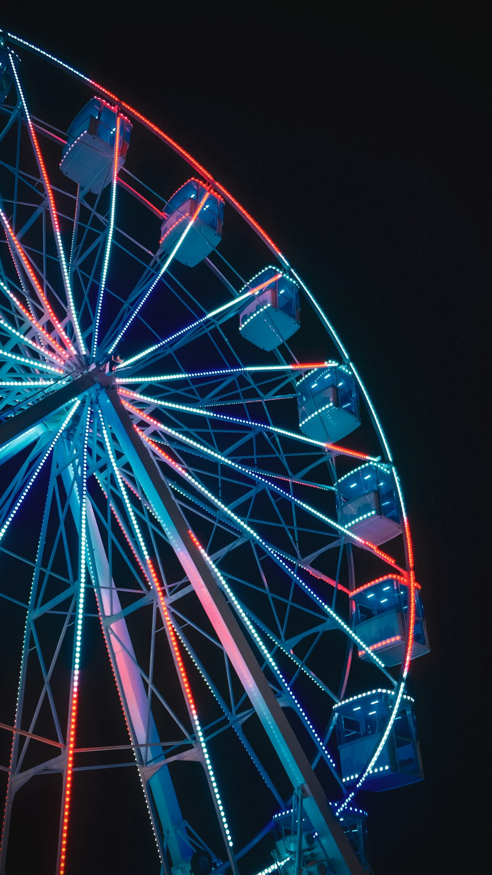 a large ferris wheel lit up at night