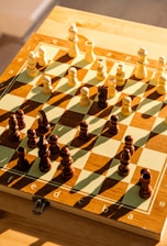a wooden chess board with chess pieces on it