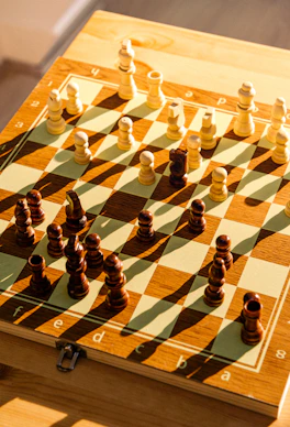 a wooden chess board with chess pieces on it