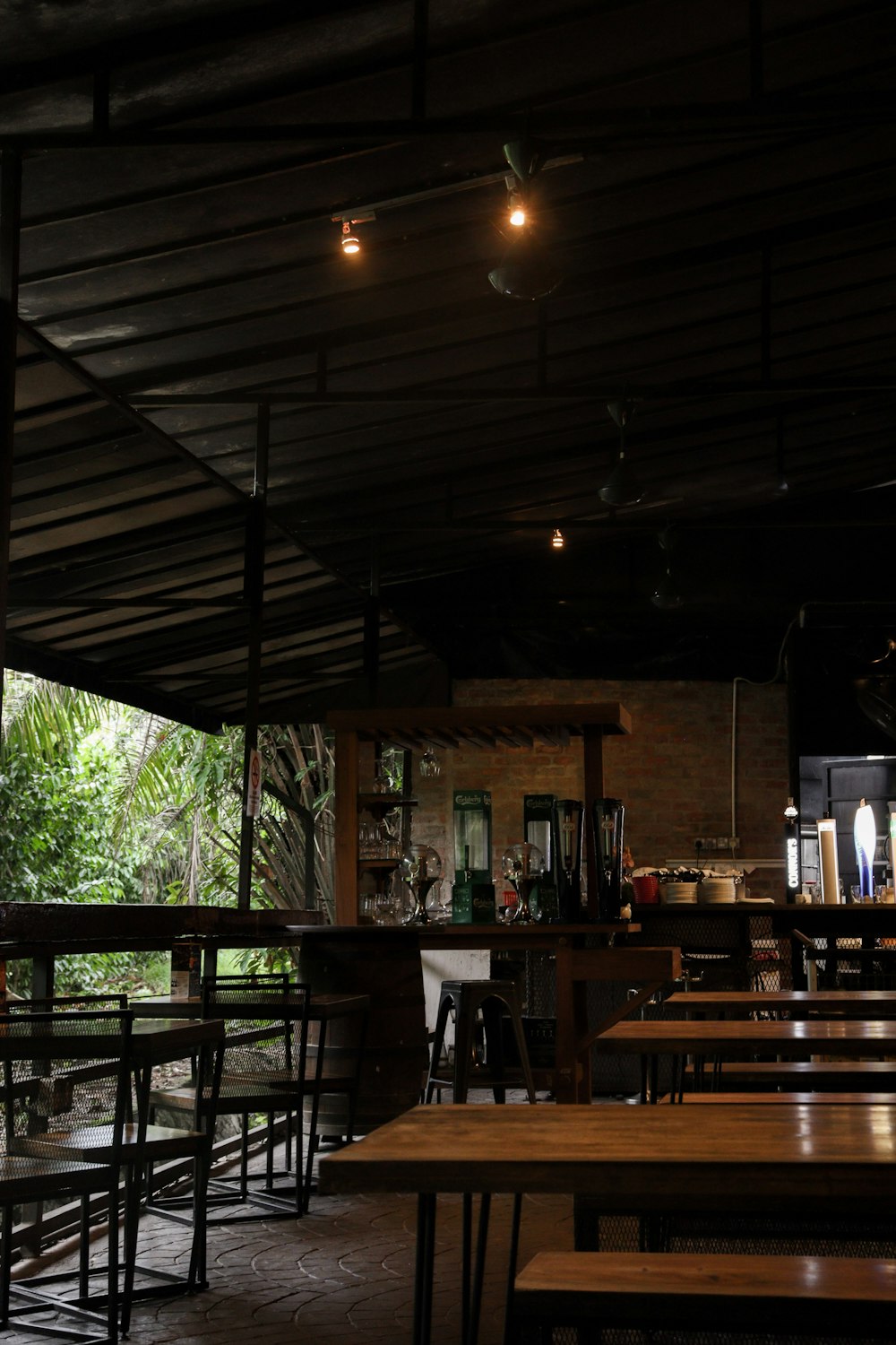 a restaurant with tables and chairs in the dark