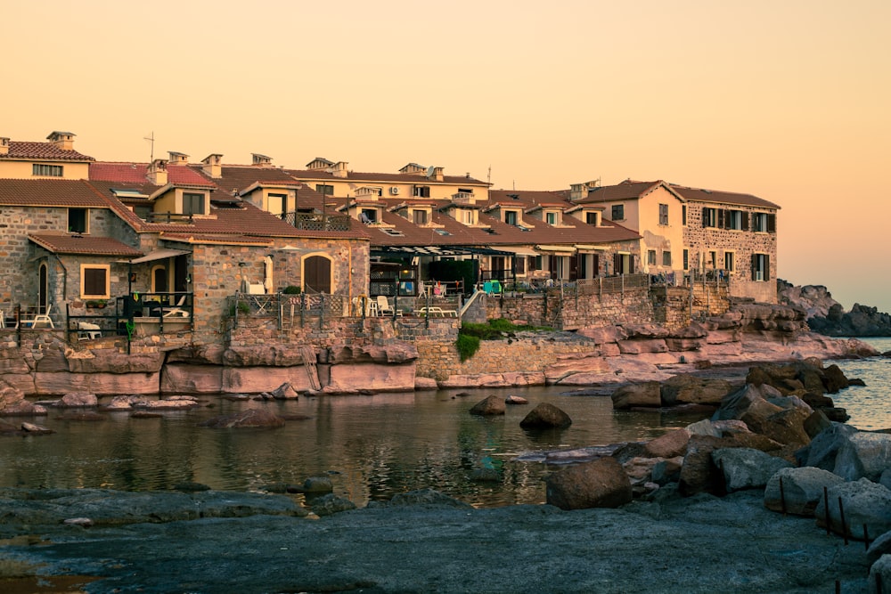 a row of houses next to a body of water