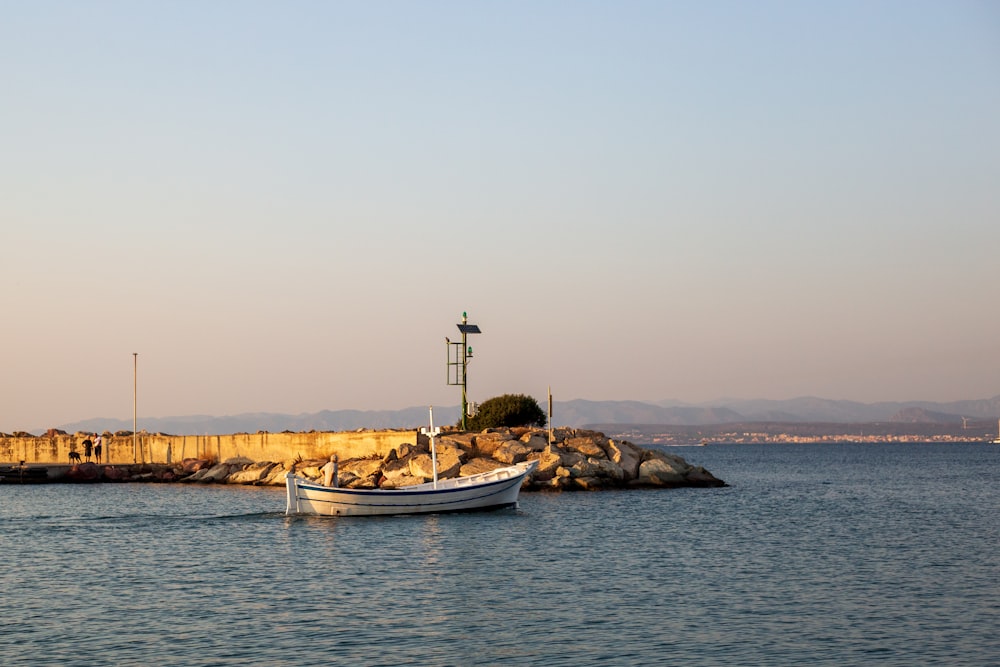 a small boat floating on top of a body of water