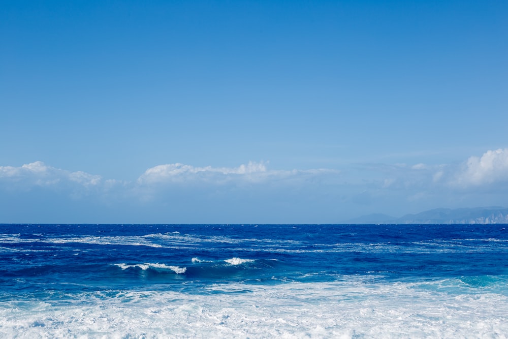 a person riding a surfboard on top of a wave in the ocean