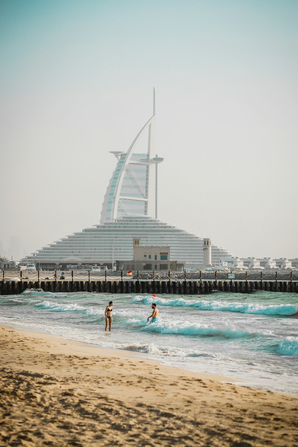 two people in the ocean near a cruise ship