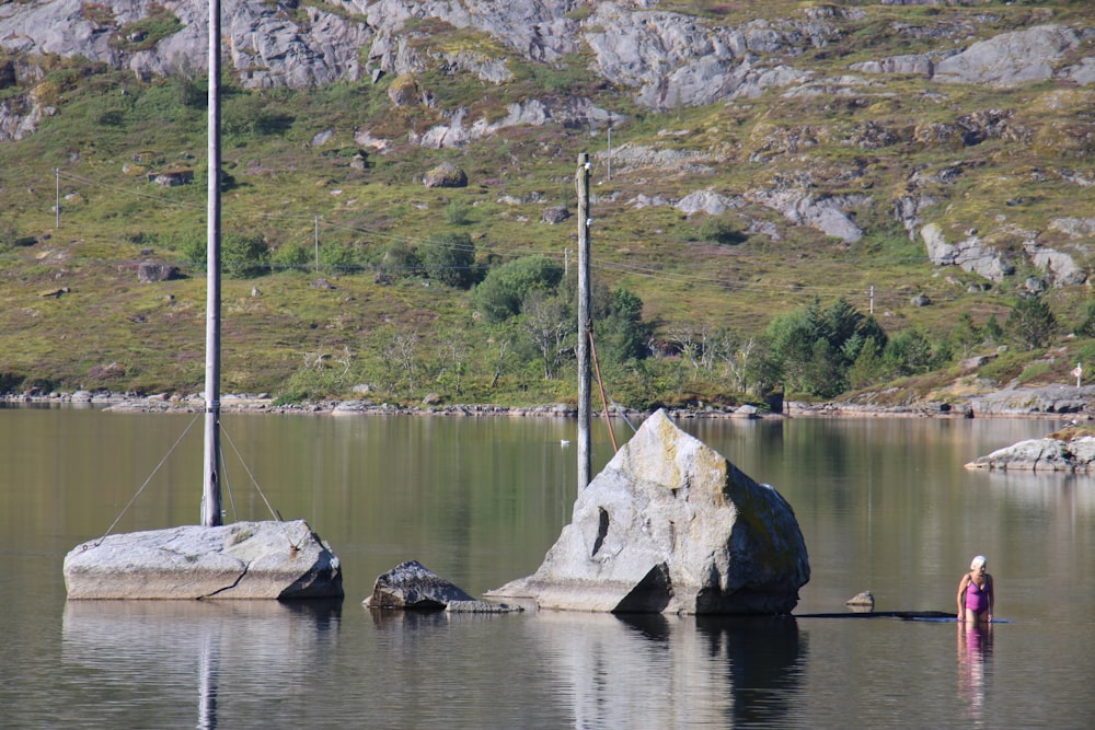 a large rock sitting in the middle of a lake