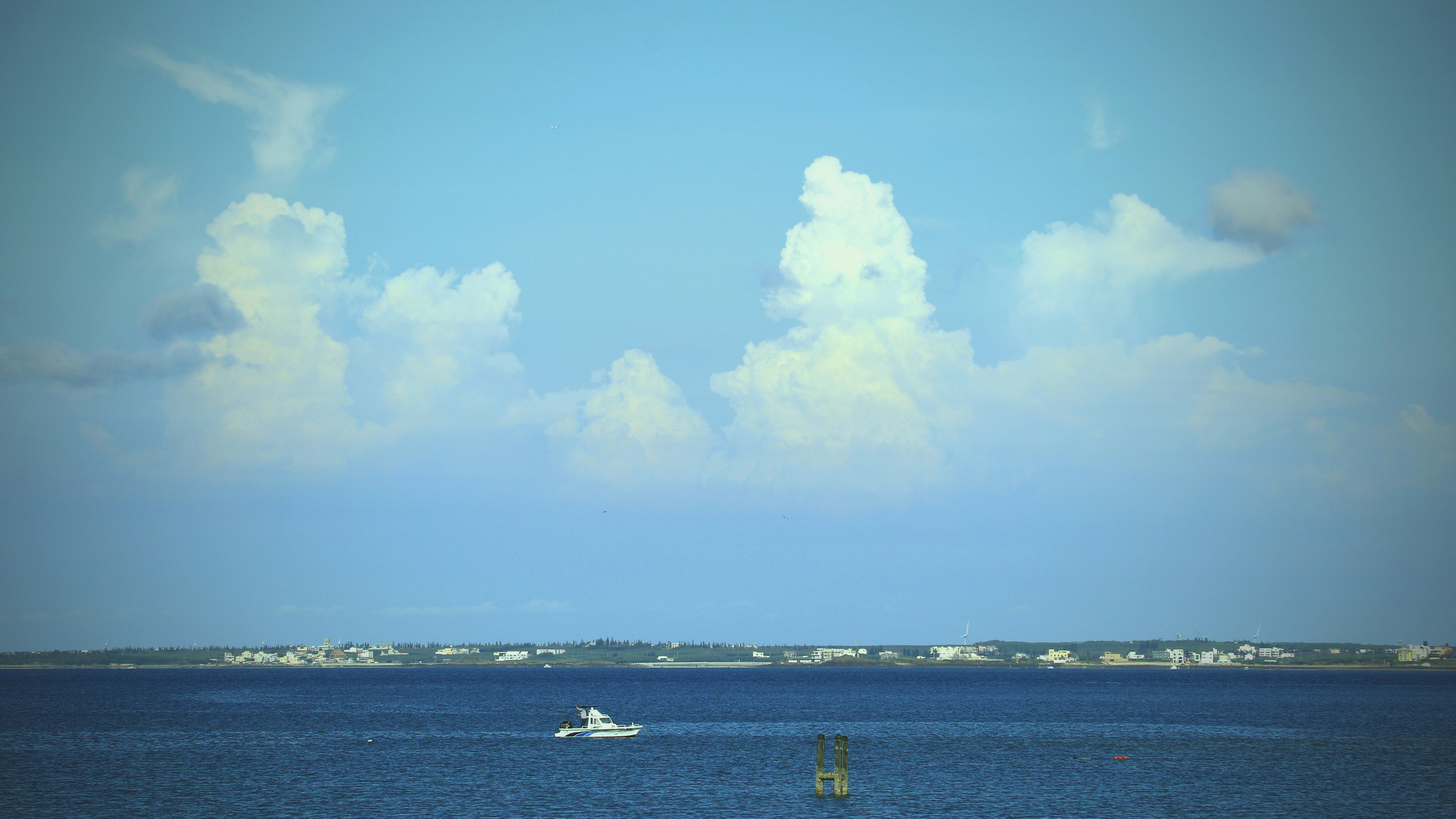 a boat is out in the ocean on a sunny day