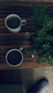 Cozy loafers placed beside a steaming cup of coffee on a rustic table