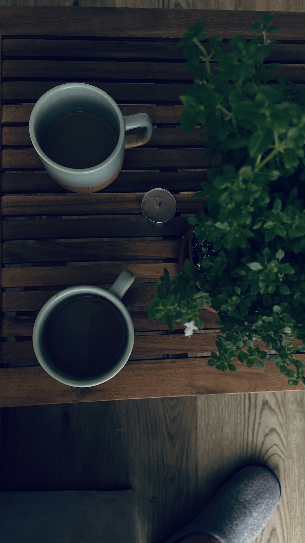 two cups of coffee on a wooden table