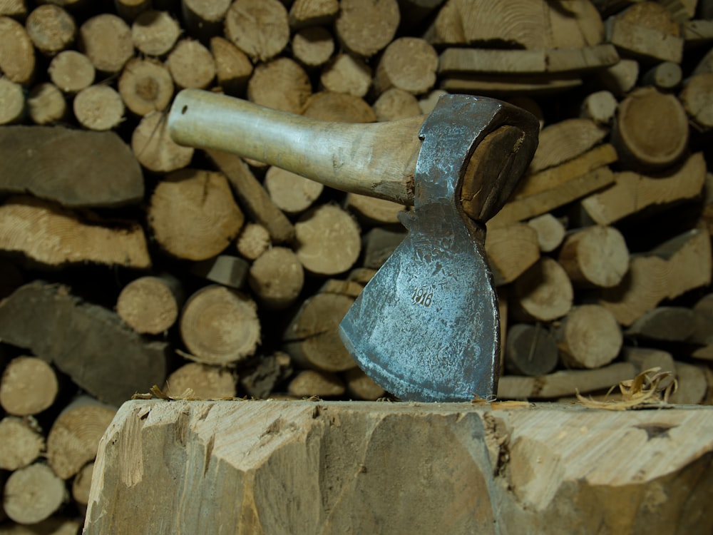 a hammer is stuck in a pile of wood