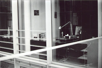 Elegant office scene with legal books and a modern laptop on a glass desk.