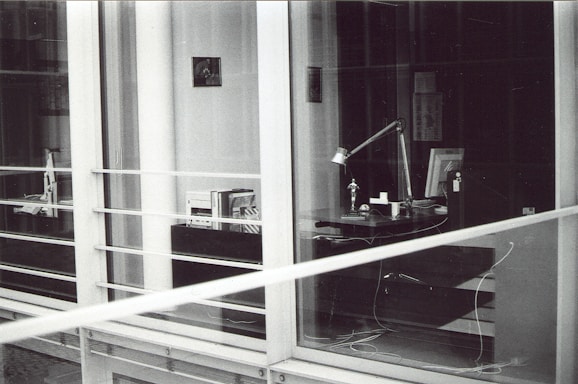 A professional office space with a modern desk and legal books in the background.