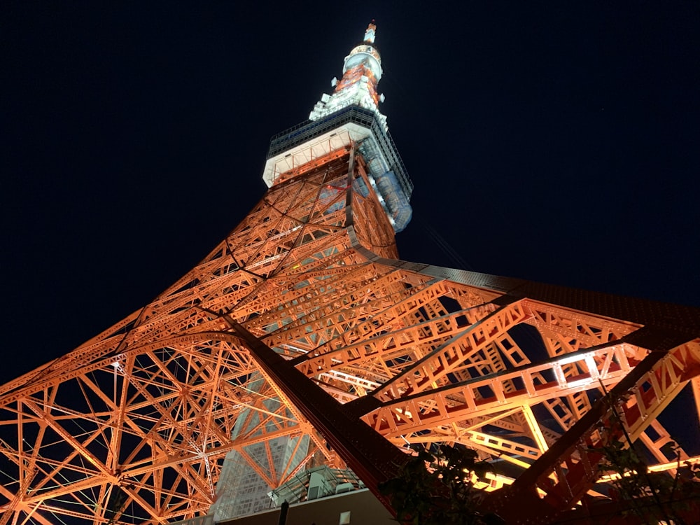 the eiffel tower is lit up at night