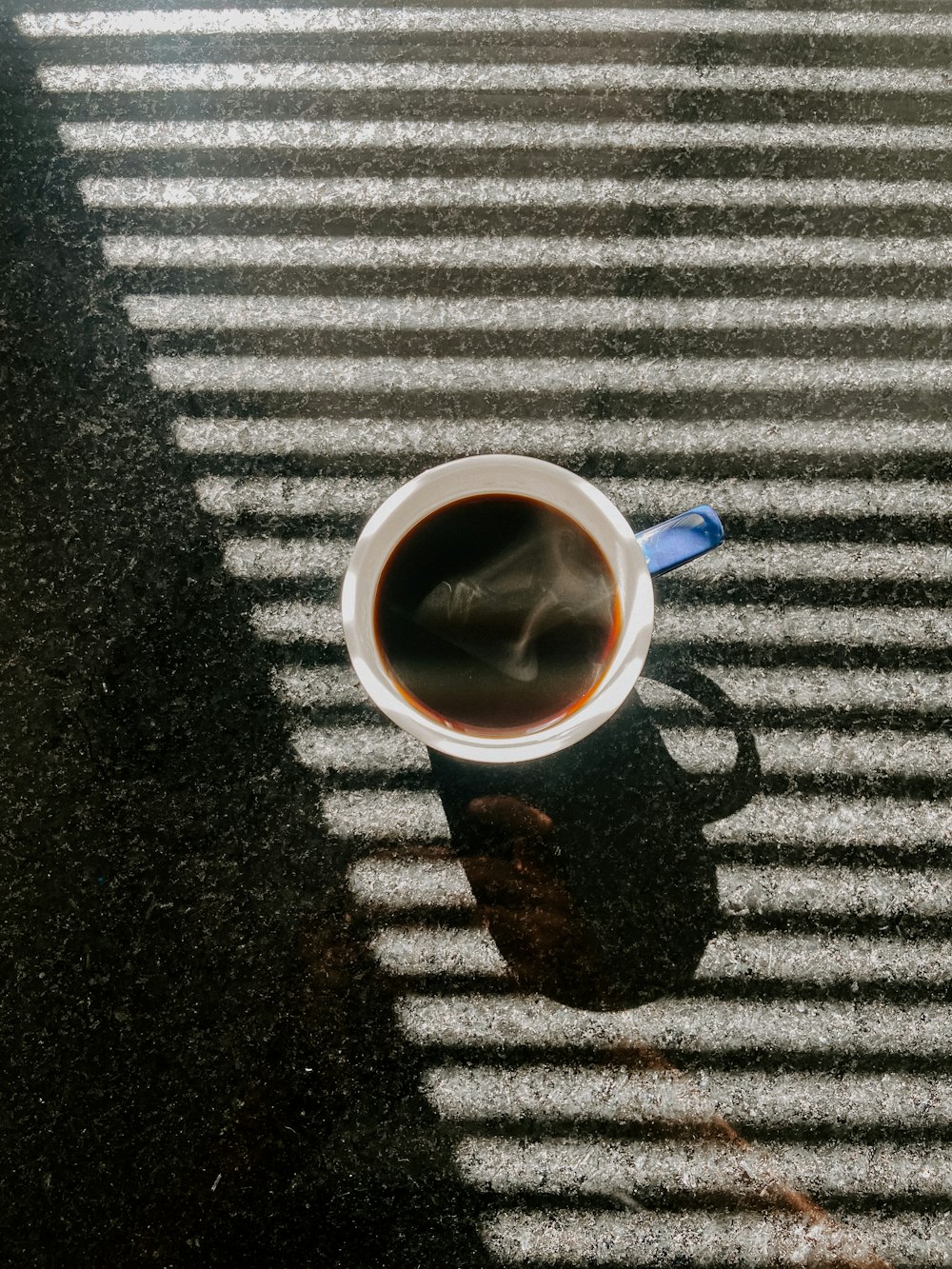 a cup of coffee sitting on top of a table