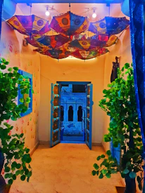 A vibrant hallway inside the Indiygo Eye Houses showcasing colorful muse artwork and publishing materials.