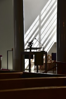 A cozy event space with a microphone and chairs arranged for a small audience.