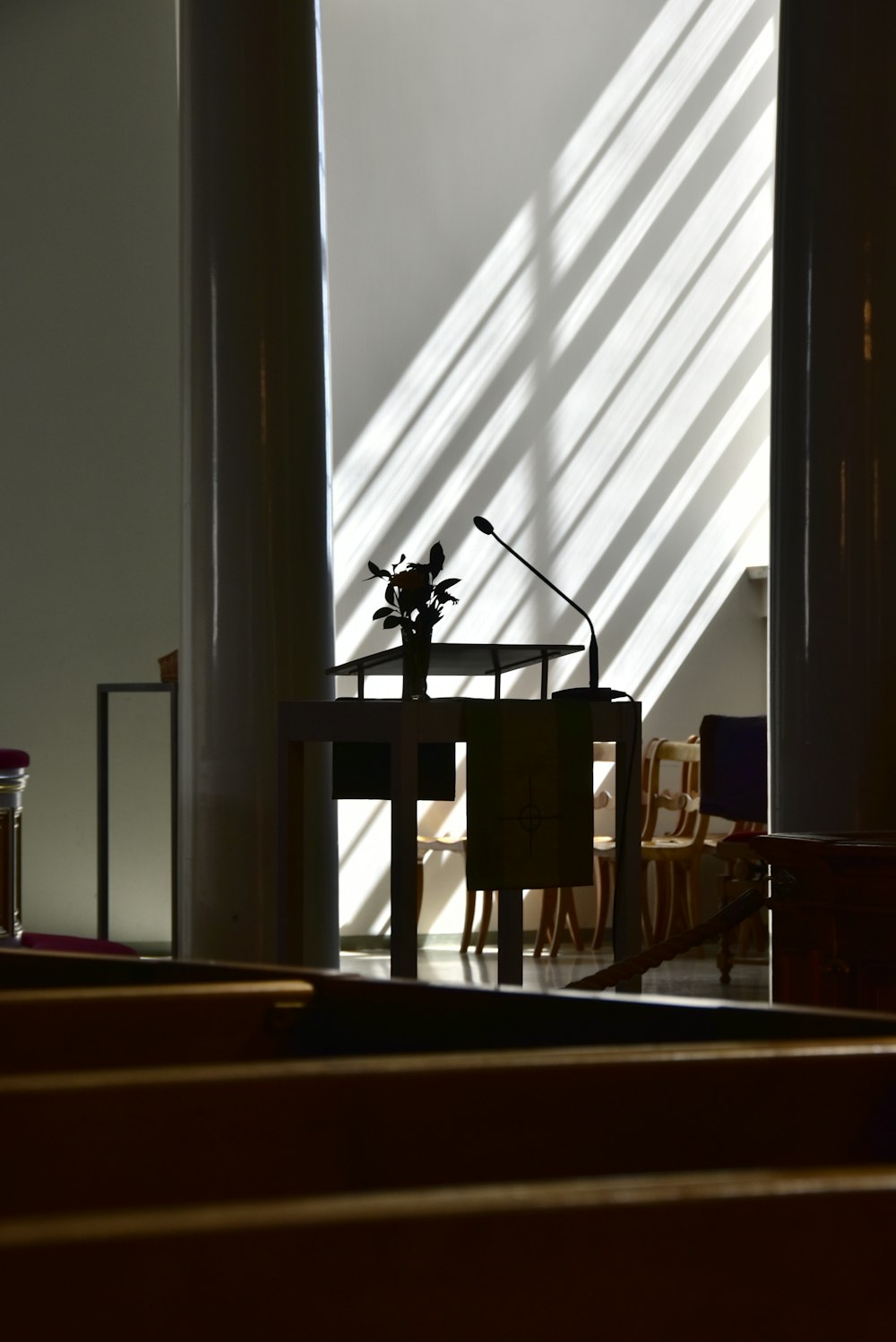 a church pew with a microphone on top of it