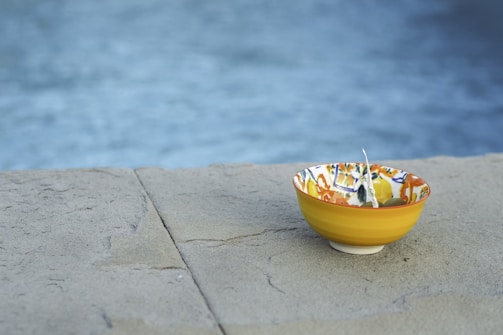 Artistic washbasin with colorful glaze and organic shape.