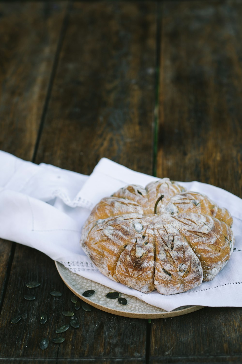 a plate topped with a pastry on top of a wooden table