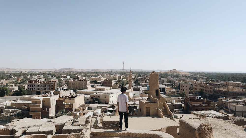 a man standing on top of a tall building