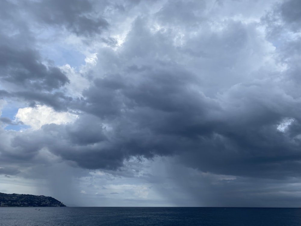 a large body of water under a cloudy sky