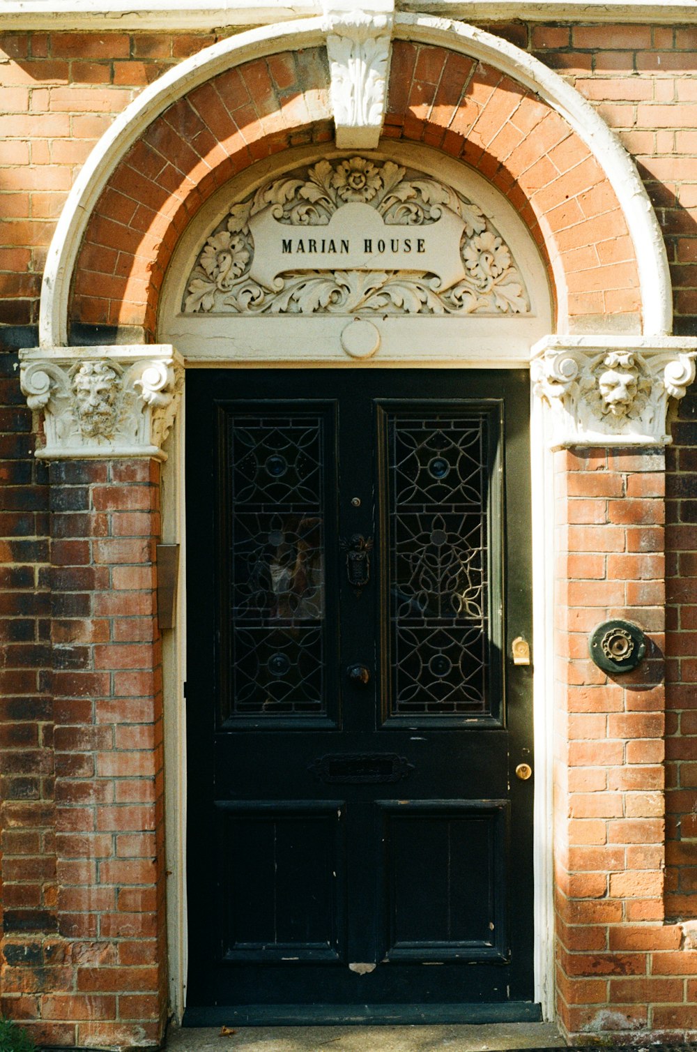 a brick building with a black front door