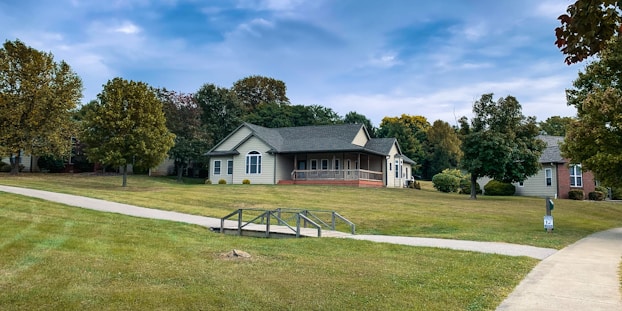 A friendly Sinclair Property Preservation team member inspecting a well-maintained suburban home.