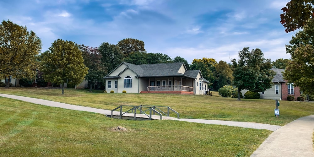 a house in the middle of a grassy field