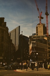 Urban intersection with traffic lights and pedestrian crossings under clear skies.