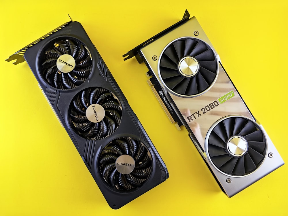 a close up of two computer fans on a yellow surface