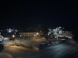 Quiet street view of Neuquén with subtle evening lighting and no people.