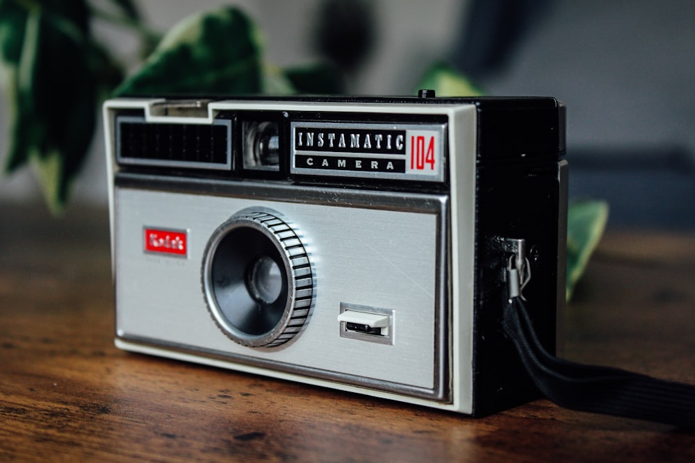 an old camera sitting on top of a wooden table