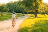 A happy female cyclist riding pain-free on a mountain trail, sunlit and focused.