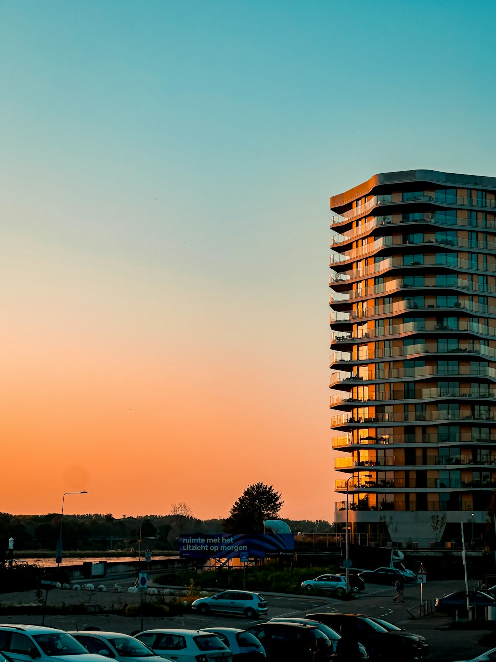 a tall building sitting next to a parking lot