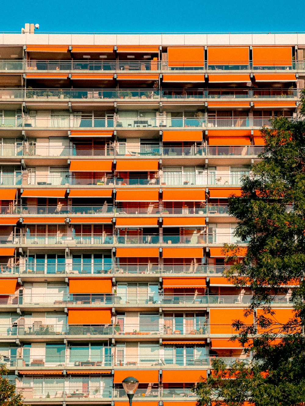 a tall orange building with balconies and balconies