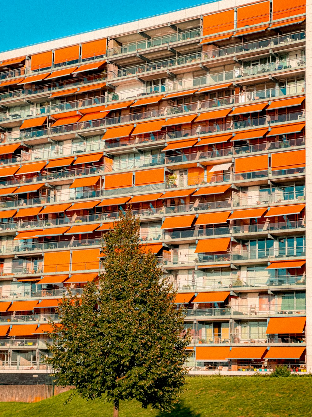 an orange apartment building with balconies and balconies
