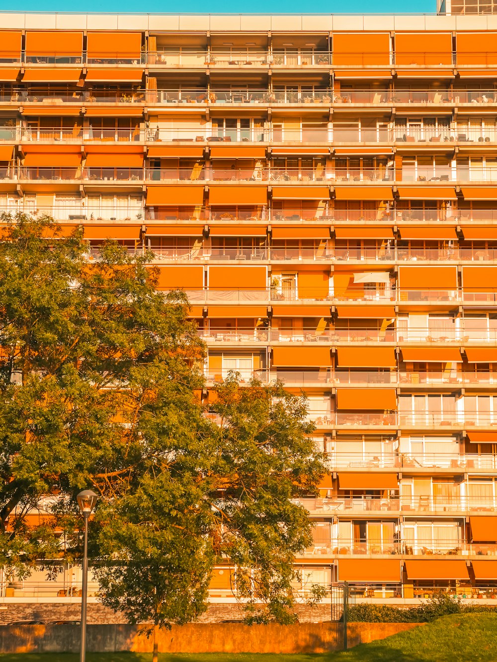 a tall orange building with balconies and balconies on it