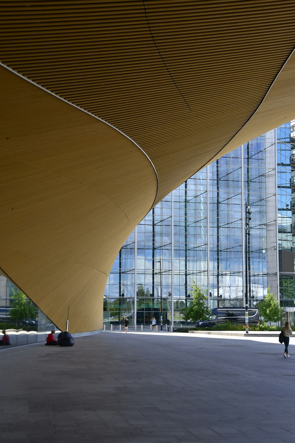 a person walking down a walkway in front of a building