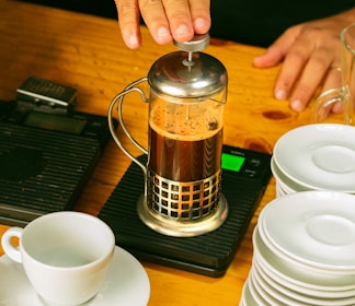 a person pours coffee into a coffee pot