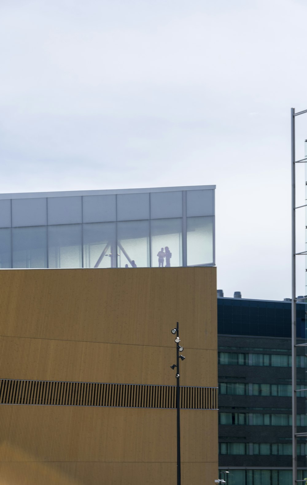 a tall building with a man standing on top of it