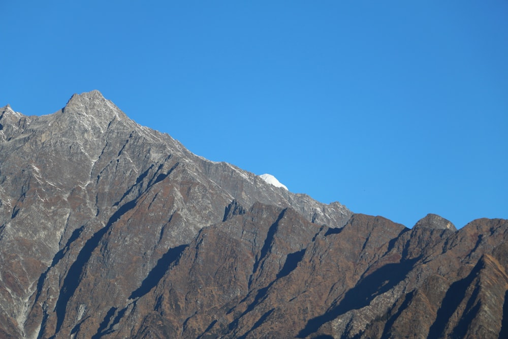 a view of the top of a mountain with a clear blue sky