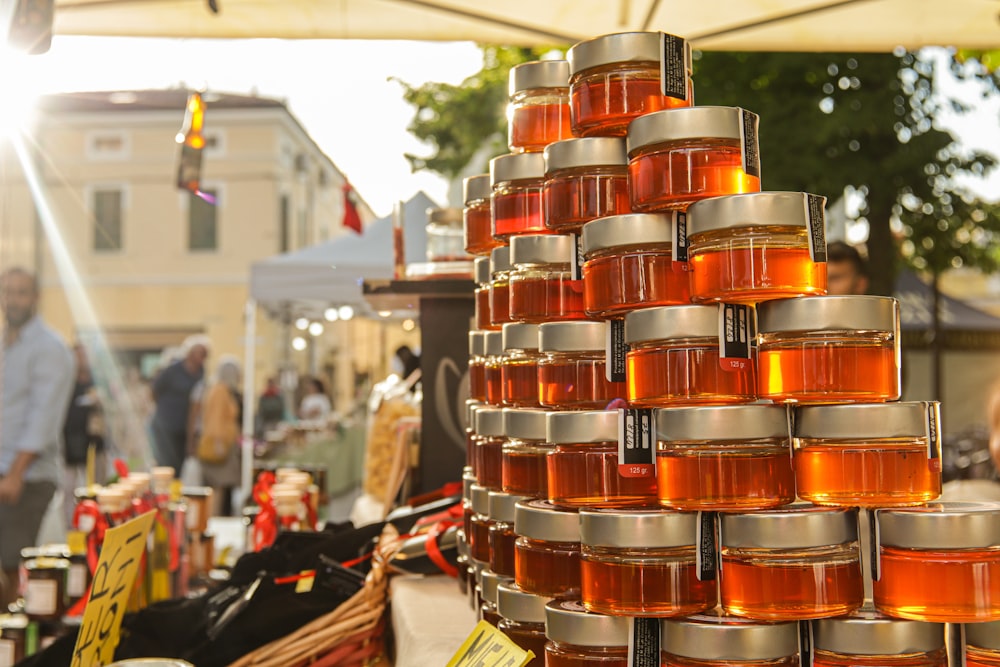 a bunch of jars of honey sitting on a table