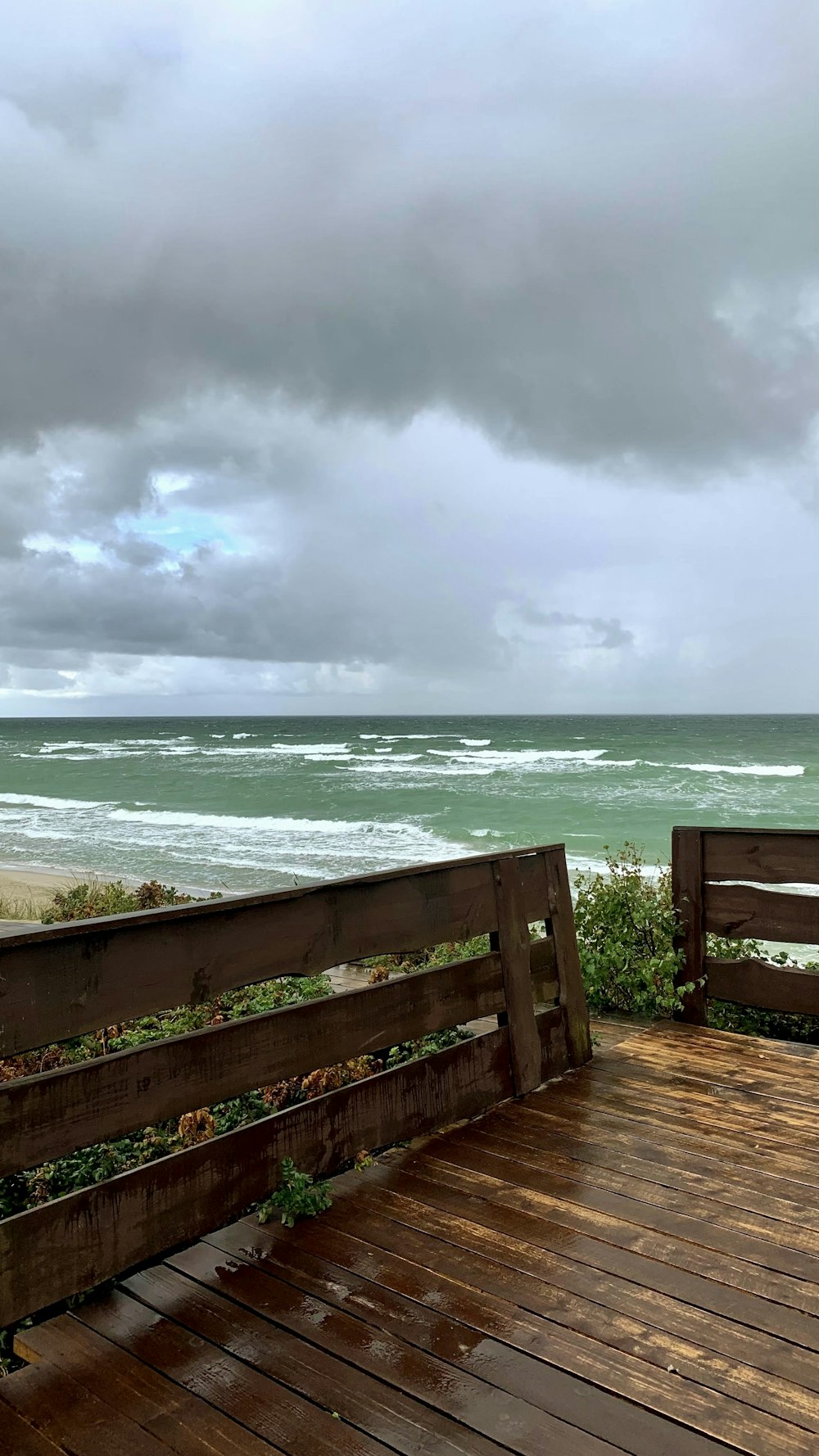 two wooden benches sitting on top of a wooden deck