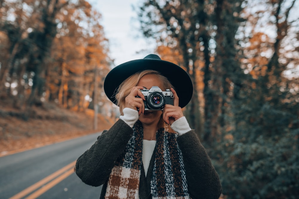 a woman taking a picture of herself with a camera