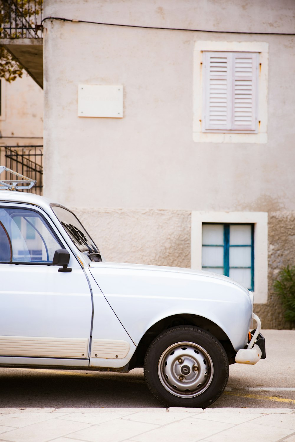 a white car parked in front of a building