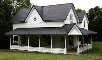 a large white house with a black roof