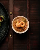 Warm and hearty feijão tropeiro served in a colorful handmade dish